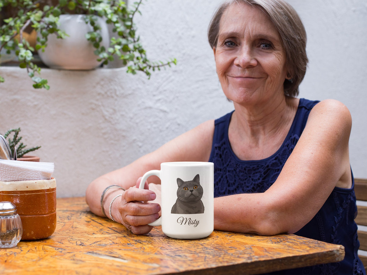 Woman at a cafe table holding a mug with a Cartoon portrait of a gray cat