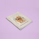 A folded golden retriever portrait blanket on a lavender backdrop.