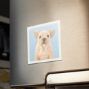 A dog portrait magnet decorates a stainless steel refrigerator above the handle.