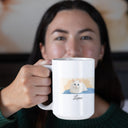 A woman holds a white mug with Luna's cat portrait and name toward the camera.