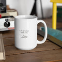 A Luna mug with a loving message sits beside vintage cameras on a wooden table.