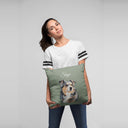 A woman holds a green pillow with Skye's dog portrait and name.