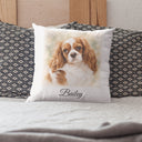 A Bailey dog portrait pillow rests between patterned pillows on a bed.