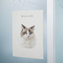 A watercolor cat portrait poster is displayed on a pale blue glass wall.