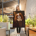 A woman holds a Royal / Renaissance spaniel portrait in a sunny courtyard.
