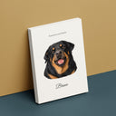 A memorial Rottweiler portrait canvas leans against a warm studio wall.
