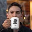 A man holds an Onyx memorial mug with a black-and-white poodle portrait.