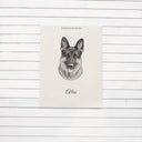 A black-and-white memorial German shepherd poster hangs on white wood panels.