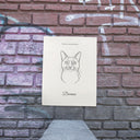 A line art memorial cat poster is displayed against a brick wall.